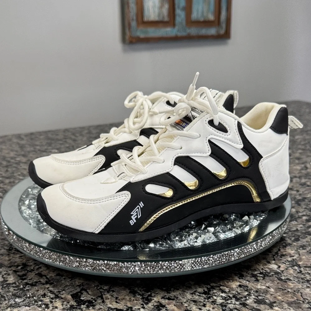 White and Black womens fashion Sneakers with gold accents EUC 10